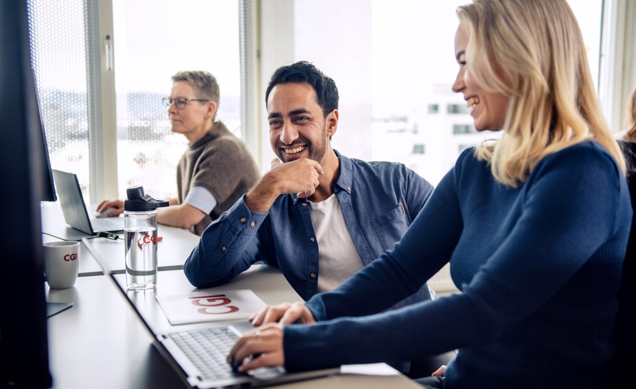 two people sat at desktop computers