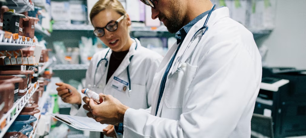 Healthcare professionals examine medication Healthcare professionals examine medication