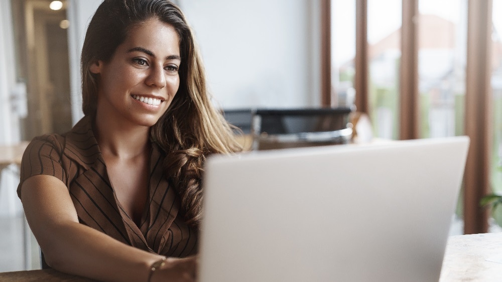 smiling woman using laptop