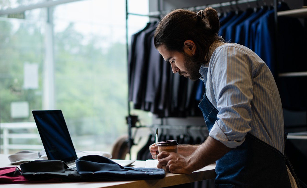 Store owner checking warehouse figures_AdobeStock_378645512