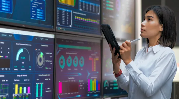 Engineer looking at the stats on wide screen