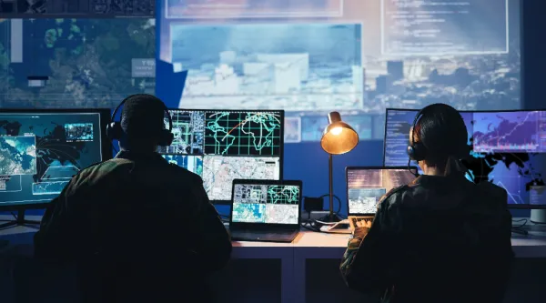 two people working in a control room