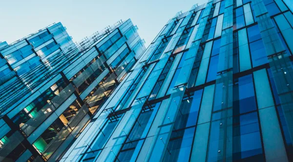 Upward-looking view of modern glass office building