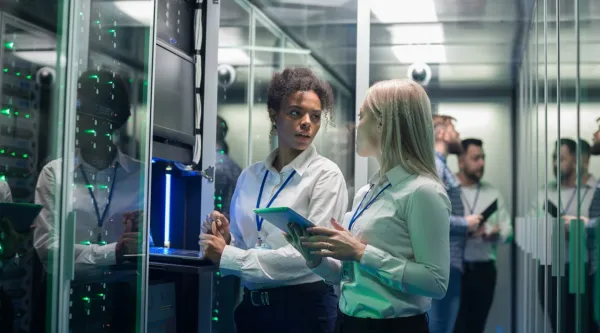 Two professionals reviewing data inside a secure data center