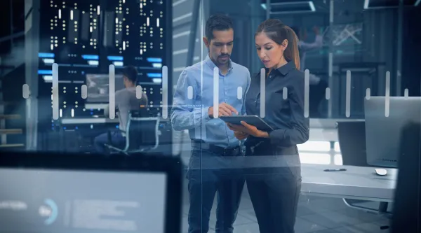 Cybersecurity operations center team looking at a tablet 