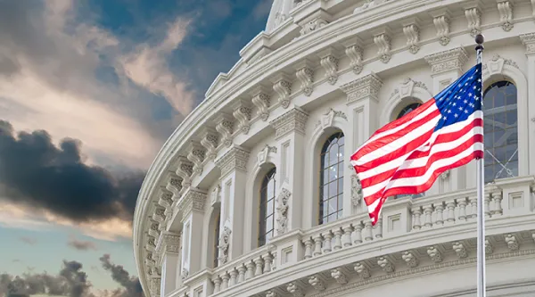 a shot of the U.S. Capital building with an American flag flying