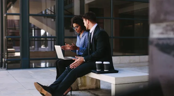 man and woman discussing on their project man and woman discussing on their project