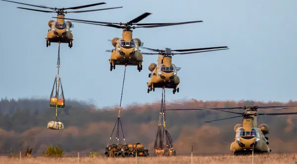 military helicopters picking up supplies