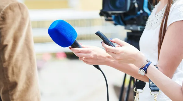 reporter with microphone conducting interview