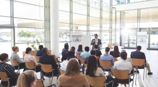 People sat at a conference listening to speaker