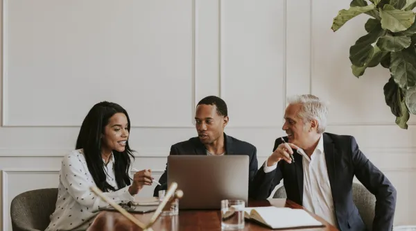 three consultants meeting at conference table