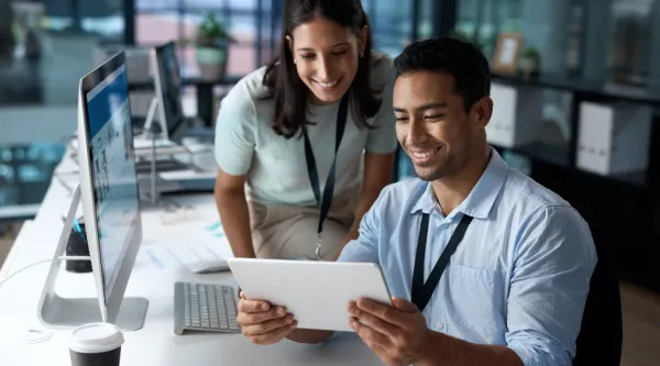 two professionals looking at a tablet