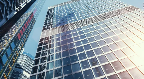 Upwards view on sun reflecting off skyscraper
