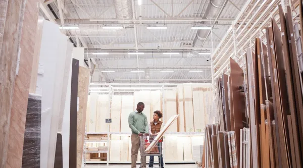 Wide angle of African American father and son shopping in hardware store