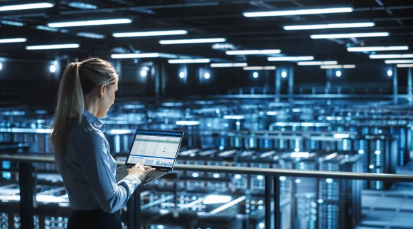 Data center IT specialist uses laptop computer