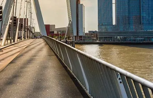 A man cycling on a bridge