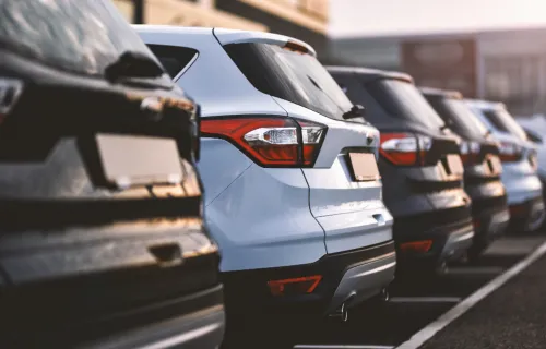 Cars parked in row on outdoor parking