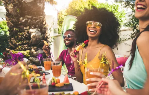 Happy woman smiling at the camera having fun with friends outdoors