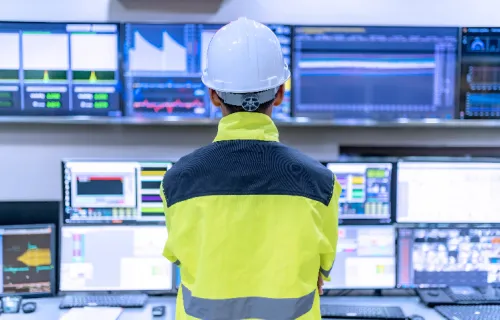 Engineer looking at screens in a control room