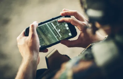 Soldier checking smartphone