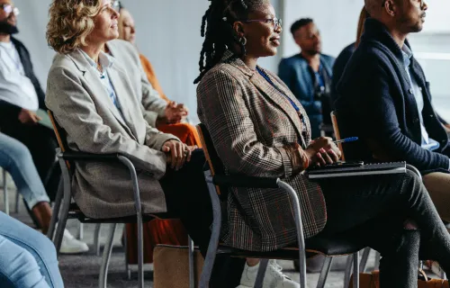 a group of people sat in chairs watching a presentation