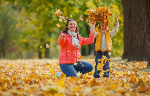 Woman and a child have fun in autumn
