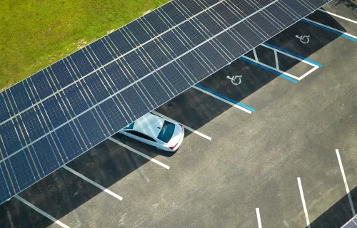 Aerial view of a car parked under solar panel covered lot