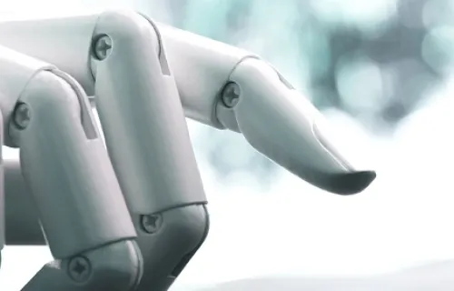 AI robot hand on a computer keyboard