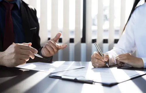 People signing an insurance contract