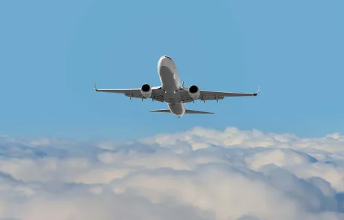 Passenger aircraft in flight above clouds