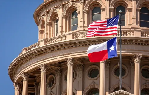 American and Texas state flags flying on the dome of the Texas State Capitol building