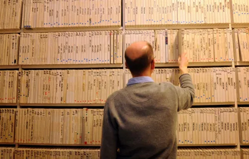 a British Library worker reviews some reel-to-reel recordings that CGI’s dira will be used to archive.