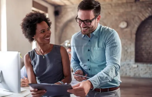 Two business people using a table and talking