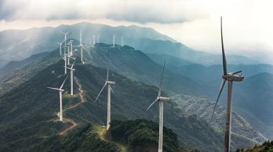 Windmill field in cloudy mountains