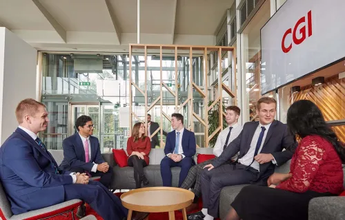 CGI professionals chatting in an office lounge