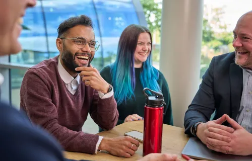 CGI professionals laughing and smiling at work
