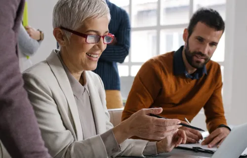 man and woman looking at laptop screen