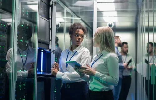 Two professionals reviewing data inside a secure data center
