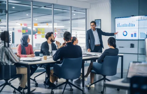 A man leads a presentation to a group of people