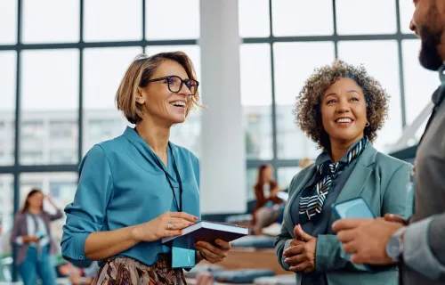 three people talking at an event