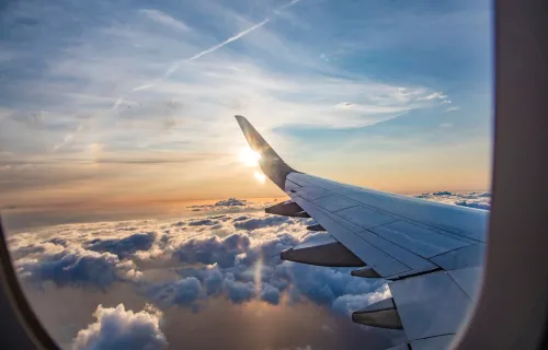view from an airplane window above the clouds
