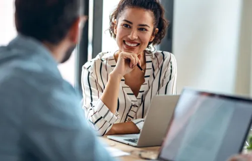 Cloud consultants look at laptop together