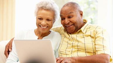 elderly couple using laptop