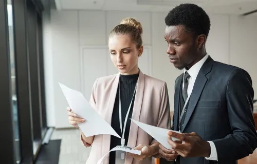 Collegues standing with documents
