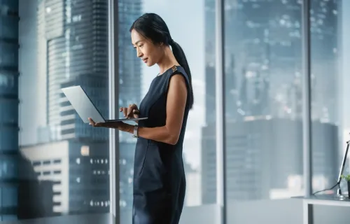 consultant at window with laptop