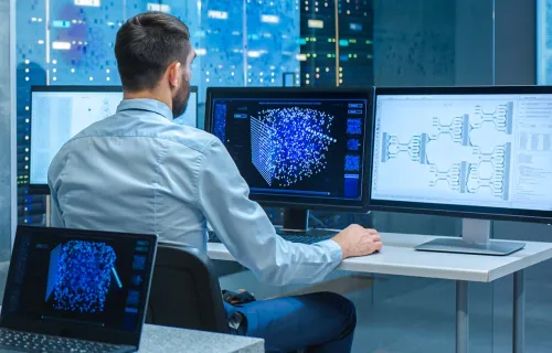 consultant reviewing AI generated data on several screens