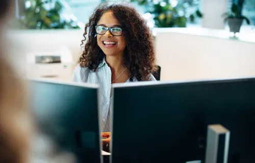 Consultant using Microsoft 365 Copilot on work computer to improve productivity