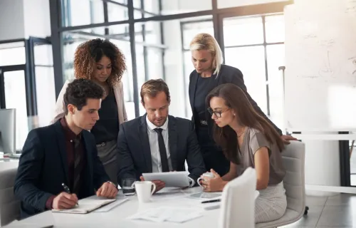 Consultants meeting around table with tablet