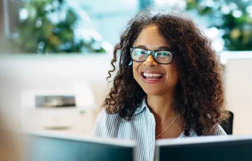 woman at computer smiling