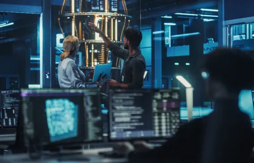 Cyber consultants gesturing to quantum computer
